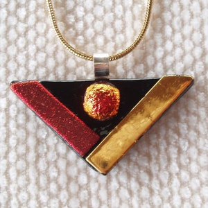 Black, red and gold triangular glass pendant