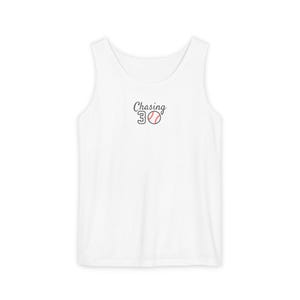 May include: A white sleeveless tank top featuring the black text Chasing and the number 30, where the zero is replaced by a white baseball graphic with red stitching centered on the chest area of the garment.