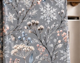 May include: A grey kitchen towel featuring a botanical pattern of blush pink berries, blue leaves, and white snowflakes. The text on the image reads A Soft Winter Touch, Muted grey tones with blush, blue, and white botanical detail.