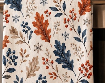 May include: A rectangular kitchen towel featuring a repeating pattern of watercolor-style oak leaves in shades of rust orange, navy blue, and beige, interspersed with clusters of red and blue berries, thin sprigs, and small black snowflake icons.