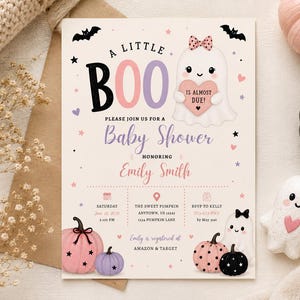 May include: A rectangular baby shower invitation card featuring a cartoon ghost with a pink heart that reads IS ALMOST DUE, pink and purple pumpkins, bats, and stars. The text reads A LITTLE BOO, PLEASE JOIN US FOR A BABY SHOWER HONORING EMILY SMITH.