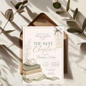May include: Bridal shower invitation with gold script text reading "The Next Chapter". The design includes a teacup, books, and floral elements. The date is June 14, 2025, at 2:00 PM. The invitation is in a brown envelope.