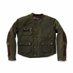 Puede incluir: Una chaqueta verde oliva con cuello alzado y correa de cuero marrón, cierre frontal de botones y cuatro bolsillos delanteros. Las mangas incluyen coderas acolchadas de color marrón oscuro y una pequeña etiqueta negra en el bolsillo.