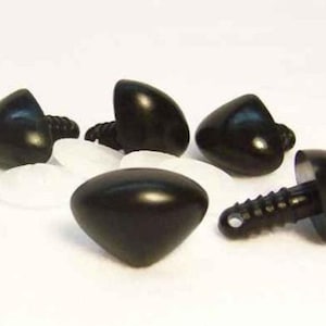May include: A collection of black plastic safety noses for plush toys, each featuring a smooth, triangular, rounded shape and a ridged plastic post on the back for secure attachment, accompanied by several translucent white plastic washers.