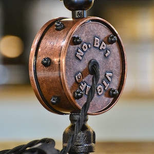 May include: A copper-colored ceiling light fixture with a black cord and a round switch that says "VTG LIFE NO. BP1".