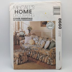 May include: A McCall's Home Decorating sewing pattern envelope 8660 for cover essentials. The front features a photograph of a floral print sofa and matching ottoman with ruffled skirts, accented by solid-colored throw pillows.