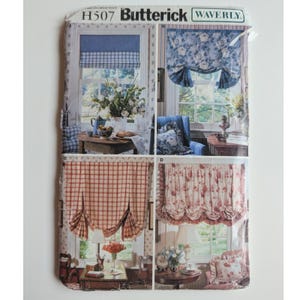 May include: A Butterick H507 Waverly sewing pattern envelope featuring four window treatment designs labeled A, B, C, and D. The images display various curtain styles including blue plaid, blue floral, red plaid, and red floral patterns on windows.