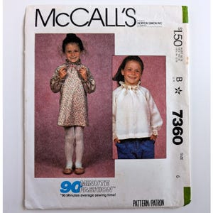 May include: A vintage McCall's 7360 sewing pattern envelope for a child's dress and blouse. The cover features two photographs of a child wearing the garments, with the text "McCALL'S", "90 MINUTE FASHION", and "7360" printed on the white paper packaging.