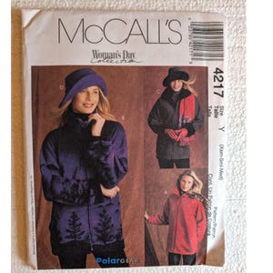 May include: McCall's 4217 Woman's Day Collection sewing pattern envelope for PolarGear jackets. The front shows three jacket variations: a purple jacket with a black tree print, a black jacket with a red scarf, and a solid red jacket.