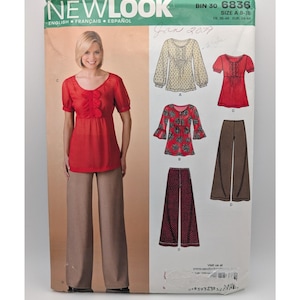 May include: New Look sewing pattern 6836 for sizes 8-18. The envelope features illustrations of tops with various sleeve lengths and necklines, along with wide-leg trousers. A model displays a red short-sleeved top and tan trousers.