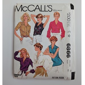 May include: A McCall's sewing pattern envelope, number 6866, featuring illustrations of six different blouse styles. The white paper envelope displays various shirt designs in colors including tan, dark floral, pink, purple, white, and blue.
