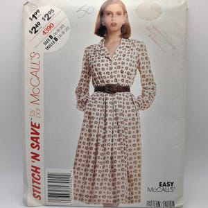 May include: A McCall's Stitch 'N Save sewing pattern envelope for a long-sleeved dress with a collar, button-down front, and a dark brown belt. The dress features a repeating small floral pattern in brown and red on a light background.