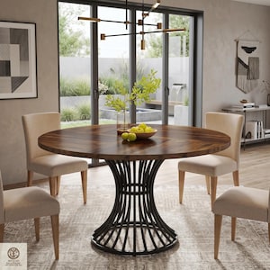 May include: A round dining table with a dark brown wood grain top and a black metal base featuring vertical curved bars. The table is surrounded by four beige upholstered chairs with light wood legs, and a bowl of green apples sits in the center.
