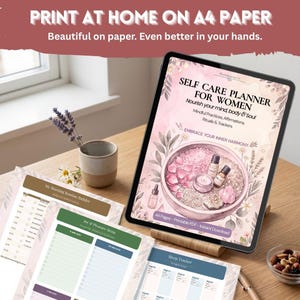May include: A digital tablet displaying a self-care planner cover with pink floral illustrations, essential oil bottles, and text reading SELF CARE PLANNER FOR WOMEN. Printed pages include a morning routine builder and sleep tracker.