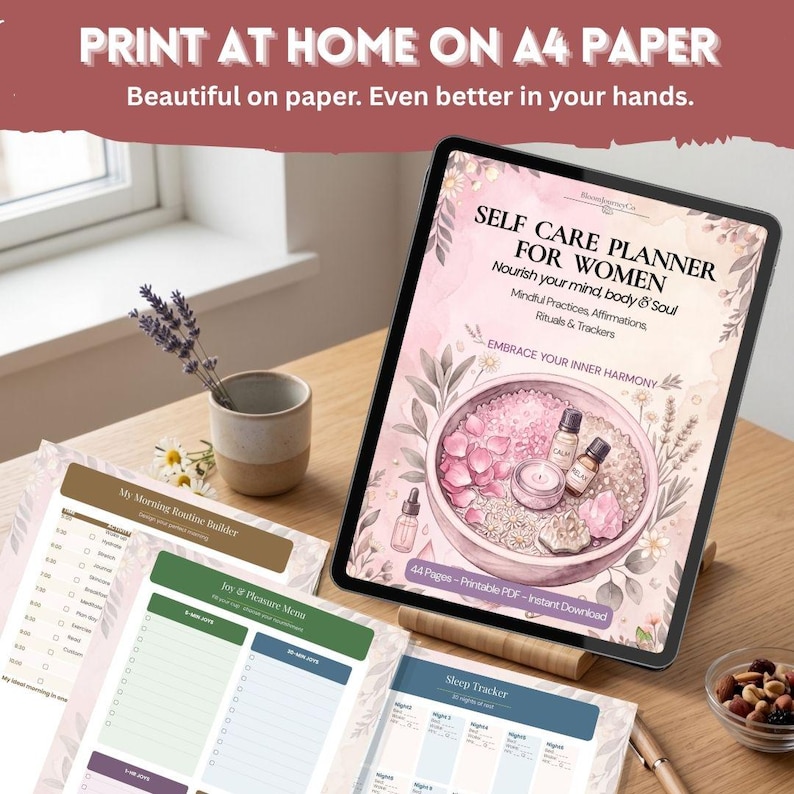 May include: A digital tablet displaying a self-care planner cover with pink floral illustrations, essential oil bottles, and text reading SELF CARE PLANNER FOR WOMEN. Printed pages include a morning routine builder and sleep tracker.