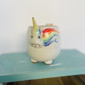 Handmade MudWorks pottery mug features a 3D "Elwood the Rainbow Unicorn" design with a hoofed base. Okay, Elwood is just plain adorable!