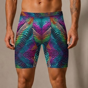 May include: Form-fitting compression shorts with a colourful snakeskin pattern. The design incorporates shades of blue, green, purple, and orange, creating a textured appearance. The shorts extend to mid-thigh.