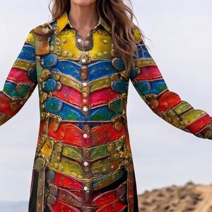 May include: A colorful button-down shirt dress with a vibrant, layered design. The dress features a spectrum of colors, including yellow, blue, red, and green, with a detailed, textured appearance. The long-sleeved dress has a collared neckline and a button-down front.
