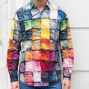 May include: A long-sleeve button-down shirt featuring a vibrant, multi-coloured collage print of denim jean pockets. The pattern includes squares of blue, yellow, orange, red, pink, and purple hues, with a standard collar and white buttons.