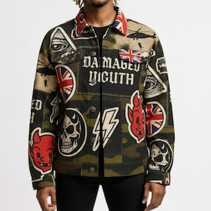 May include: A camouflage jacket with various patches, including skulls, lightning bolts, and the text "DAMAGED YOUTH." The jacket has a red, white, and blue collar and cuffs, and is worn over a black shirt and black pants.