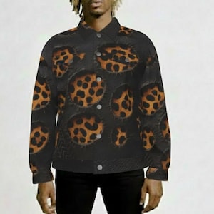 May include: Black button-up jacket with a repeating pattern of brown and black leopard spots. The jacket has a classic collar and button closures. The garment is worn with black pants.
