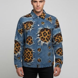 May include: A blue denim jacket with a unique leopard print design. The jacket features a classic button-up front, chest pockets, and a collared neckline. The leopard print is strategically placed throughout the jacket, creating a bold and fashionable statement.