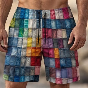 May include: Swim shorts featuring a vibrant, multi-coloured grid pattern composed of various rectangular blocks in shades of blue, red, yellow, green, and purple. The shorts have an elastic waistband with a black drawstring cord at the centre.