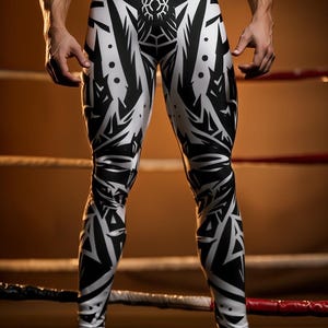 May include: White and black patterned leggings. The leggings feature a repeating geometric design in black against a white background. The design covers the entire surface of the leggings. The leggings are form-fitting and appear to be made of a stretchy material.