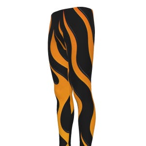 May include: Black leggings with a vibrant orange flame design. The leggings feature a high-waisted fit and a bold, eye-catching pattern. The flame design is a striking contrast against the black background, creating a dynamic and energetic look.