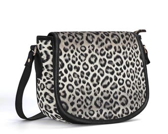 May include: A black and white leopard print crossbody bag with a black strap and a gold zipper.