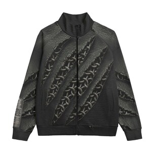 May include: Black zip-up jacket with a distressed leather look. The design features claw marks revealing a chainmail pattern underneath. The jacket has a high collar and a small tag with text and a QR code on the left sleeve.