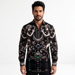 May include: A long-sleeved black button-down shirt featuring a detailed print of silver cherubs, ornate floral motifs, and large emerald and sapphire-coloured gemstones. The design includes vertical pinstripes near the collar and cuffs.