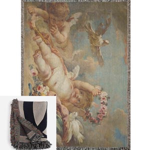 May include: A woven tapestry throw blanket featuring a vintage illustration of cherubs and doves in a cloudy sky. The cherubs are depicted with wings and holding a wreath of flowers. The colors are muted and include shades of brown, blue, and white.