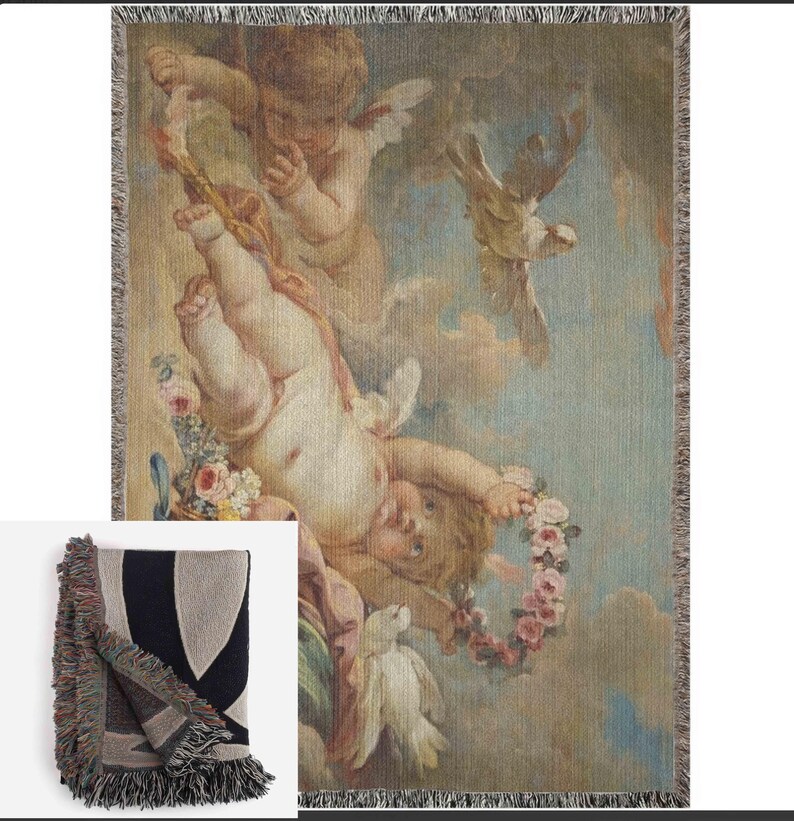 May include: A woven tapestry throw blanket featuring a vintage illustration of cherubs and doves in a cloudy sky. The cherubs are depicted with wings and holding a wreath of flowers. The colors are muted and include shades of brown, blue, and white.