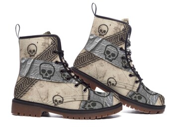 May include: Pair of combat boots with a cream-colored background and a repeating skull pattern. The boots feature black laces, a brown sole, and patches of gray tape. The design includes tire track and geometric patterns.