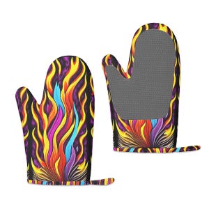 May include: A pair of colorful oven mitts with a flame design. The mitts are black with yellow, orange, pink, and blue flames. The mitts have a textured gray silicone lining.