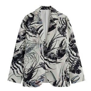 May include: A white blazer with a black and white lobster print. The blazer has a classic cut and a single button closure.