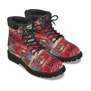 May include: Black-soled boots with a red and white design. The boots feature a skull and crossbones pattern and the word "SMASHED" in red. The boots have black laces and a black collar.