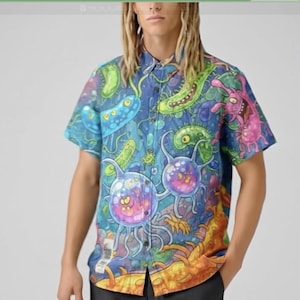 May include: Short-sleeved shirt with a button-down collar, featuring a vivid print of cartoon microorganisms in blue, green, pink, and orange. The shirt has a relaxed fit, ideal for casual wear, and is a bold fashion statement.