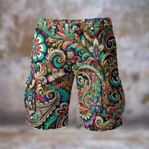 May include: Shorts with a vivid paisley design in teal, pink, yellow, and green floral and scrollwork on a black backdrop. The shorts have pockets and a button closure. The design is intricate.