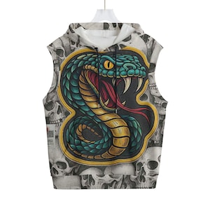 May include: Sleeveless hoodie with a vibrant snake illustration in green, yellow, and red. The snake design is framed by a gold border, set against a background of skulls. The hoodie has a white hood and a drawstring.