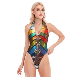 May include: Halter-style one-piece swimsuit with a vibrant, colorful design. The swimsuit features a rainbow-like pattern with metallic accents and a decorative, ornate central design. The neckline is a deep V-neck.