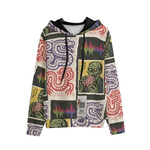 May include: A black hooded sweatshirt with a colorful, repeating pattern. The design includes zombie illustrations, abstract shapes, and a variety of colors. The hoodie has a black interior and drawstrings.