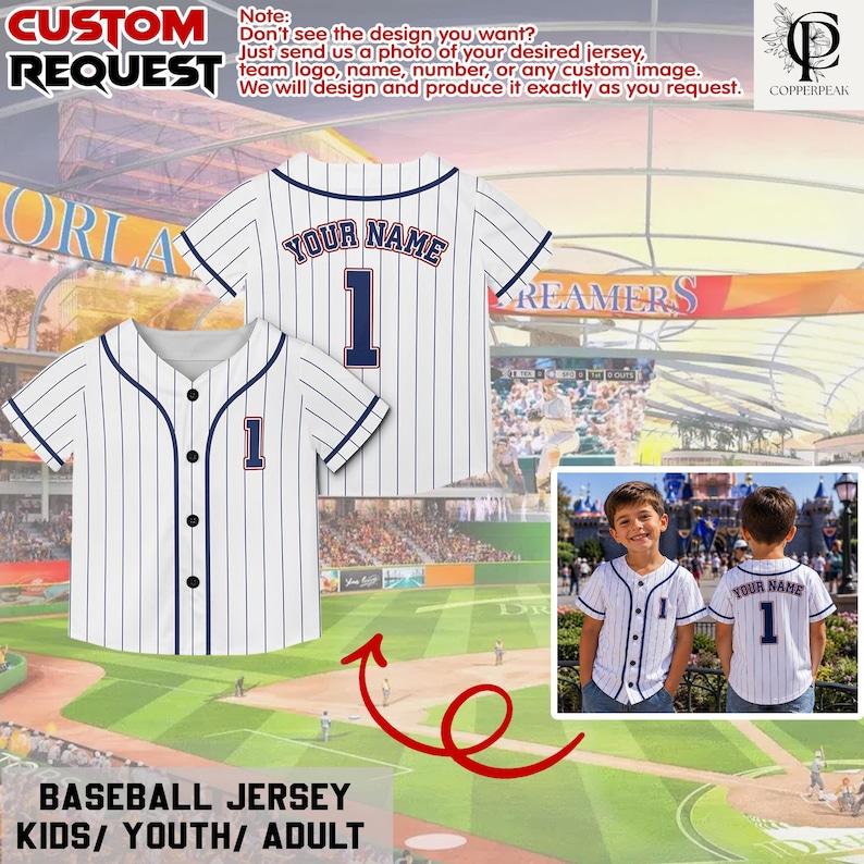 Puede incluir: Una camiseta de b&eacute;isbol blanca con finas rayas verticales azul marino, cierre de botones y ribetes azul marino. La camiseta presenta el texto YOUR NAME y el n&uacute;mero 1 en azul marino con un borde rojo en la parte posterior y en el pecho.