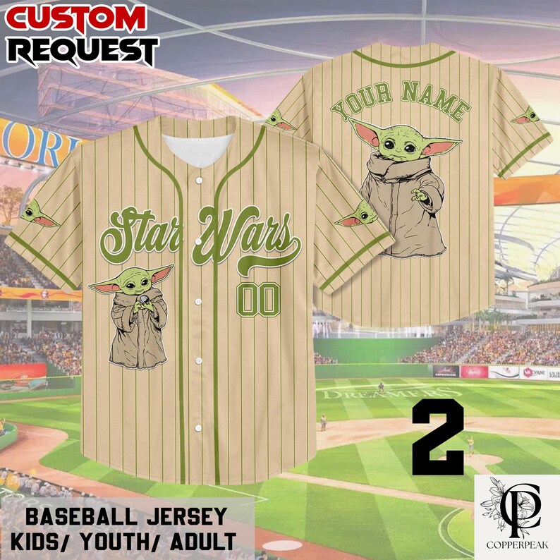 Puede incluir: Una camiseta de b&eacute;isbol color canela con rayas verticales finas y ribetes verdes. El frente presenta el texto Star Wars, el n&uacute;mero 00 y un gr&aacute;fico de una peque&ntilde;a criatura verde. La parte posterior muestra el texto Your Name y un gr&aacute;fico similar.