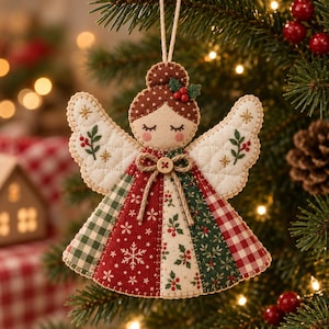 May include: A fabric angel ornament featuring a brown hair bun with red berries, closed eyes, and pink cheeks. The wings are quilted white fabric with embroidered green leaves and red berries. The dress is a patchwork of red, green, and white patterns.