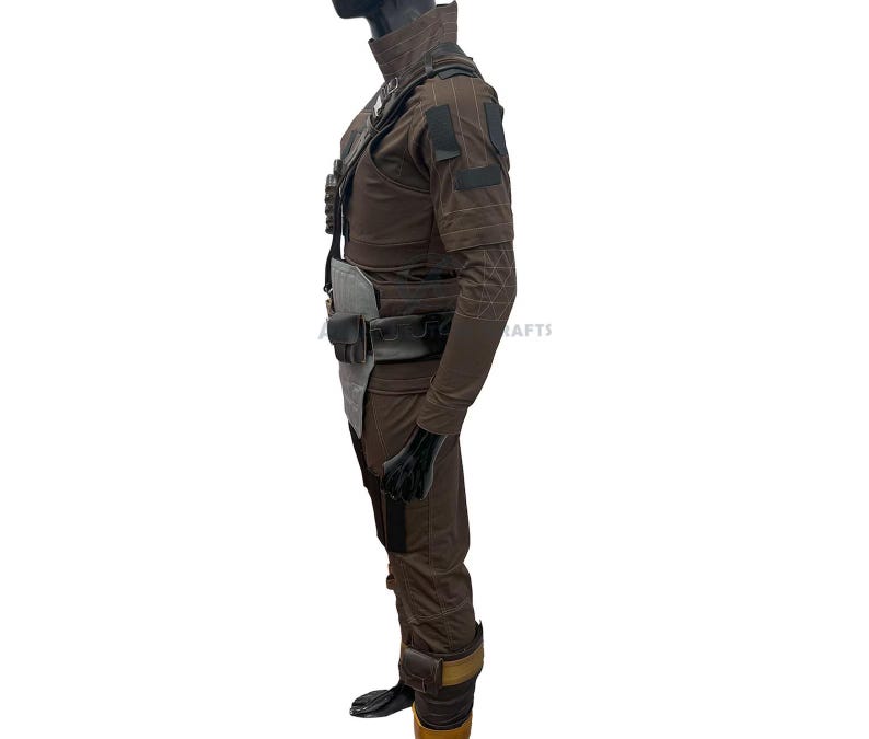 May include: A brown tactical jumpsuit featuring a high collar, long sleeves with geometric stitching, and a dark utility harness. The outfit includes a grey chest plate, a black belt with a small pouch, and dark brown leg coverings with tan accents.