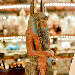 Heavy Large seated Anubis holding a mummy form with a Hapi (Son of Horus)