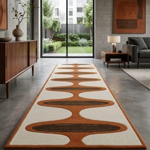 May include: A long rectangular runner rug featuring a repeating pattern of interconnected oval shapes. The design consists of dark brown centers surrounded by burnt orange borders, all set against a cream-colored background, creating a bold graphic motif.