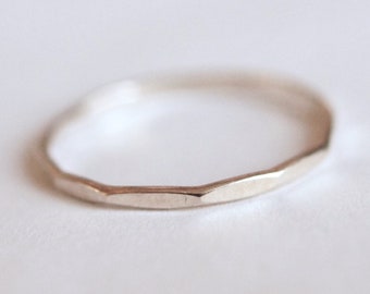 Skinny silver stacking ring, 1.15mm thick, flat hammered faceted texture.